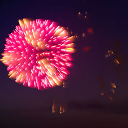 Low angle view of firework display at night