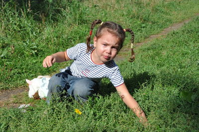 Cute boy looking away on grass