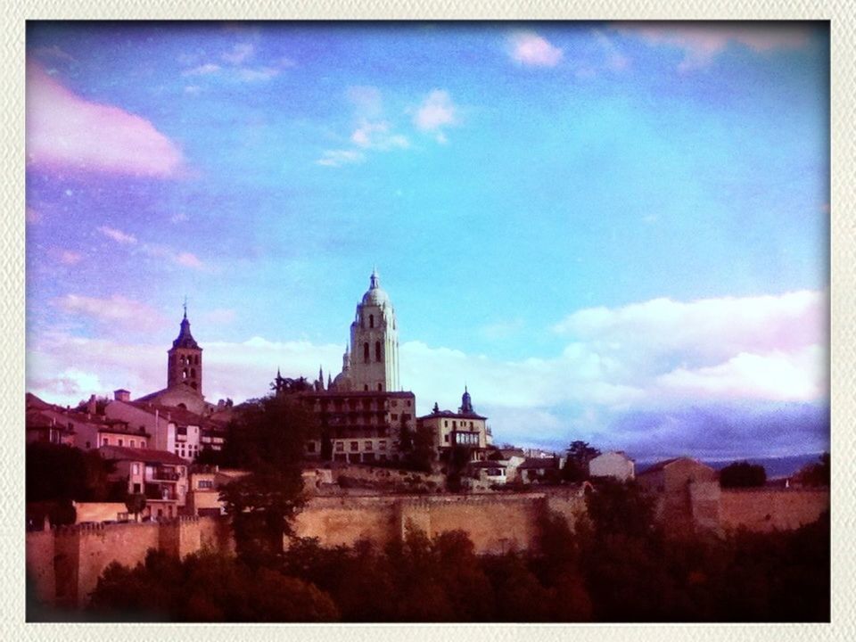 VIEW OF BUILDINGS AGAINST CLOUDY SKY