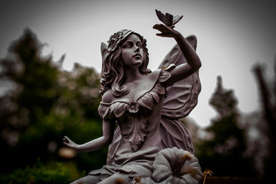 Low angle view of statue against sky
