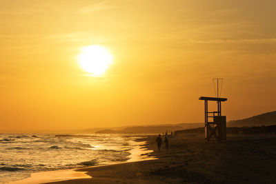 Scenic view of sea against orange sky