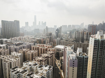 High angle view of modern buildings in city against sky