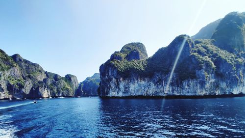 Panoramic view of sea and mountains against clear sky