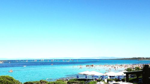 Scenic view of beach against clear blue sky