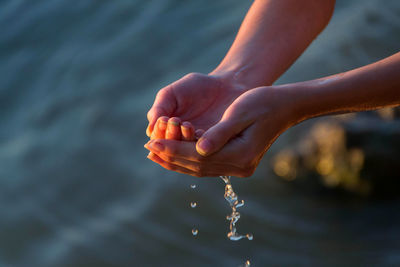 Close-up of hand holding water