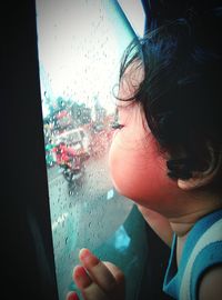 Close-up of woman looking through car window