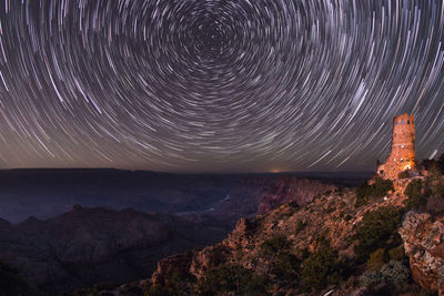 Scenic view of illuminated mountain against sky at night