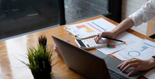 High angle view of woman using laptop on table