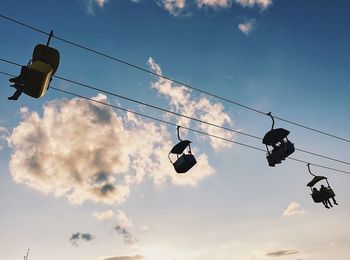 Low angle view of overhead cable car against sky