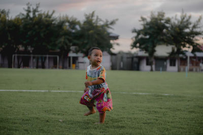 Full length of girl standing on field