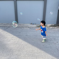 Full length of boy playing with toys on road