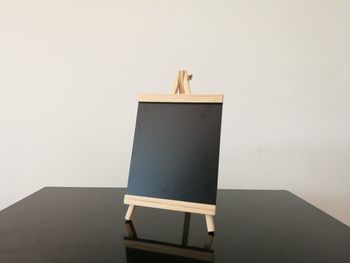 Chair on table against white wall
