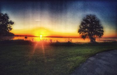 Scenic view of field against sky during sunset