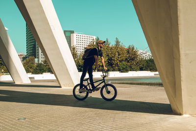 Man riding bicycle on city street