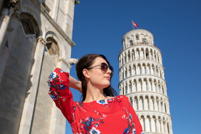 Portrait of woman against red building