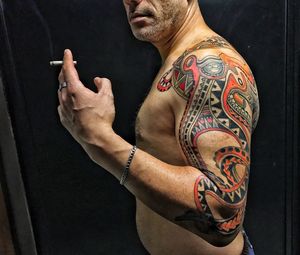 Midsection of tattooed man with cigarette