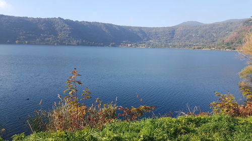 Scenic view of lake and mountains against sky