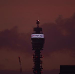 Low angle view of illuminated building against sky at night