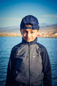 Portrait of smiling boy standing in sea