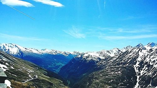 Scenic view of mountains against blue sky