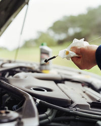 Mechanic checking oil in car