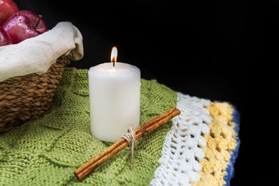 Close-up of burning candles on table