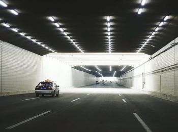 Cars in illuminated tunnel