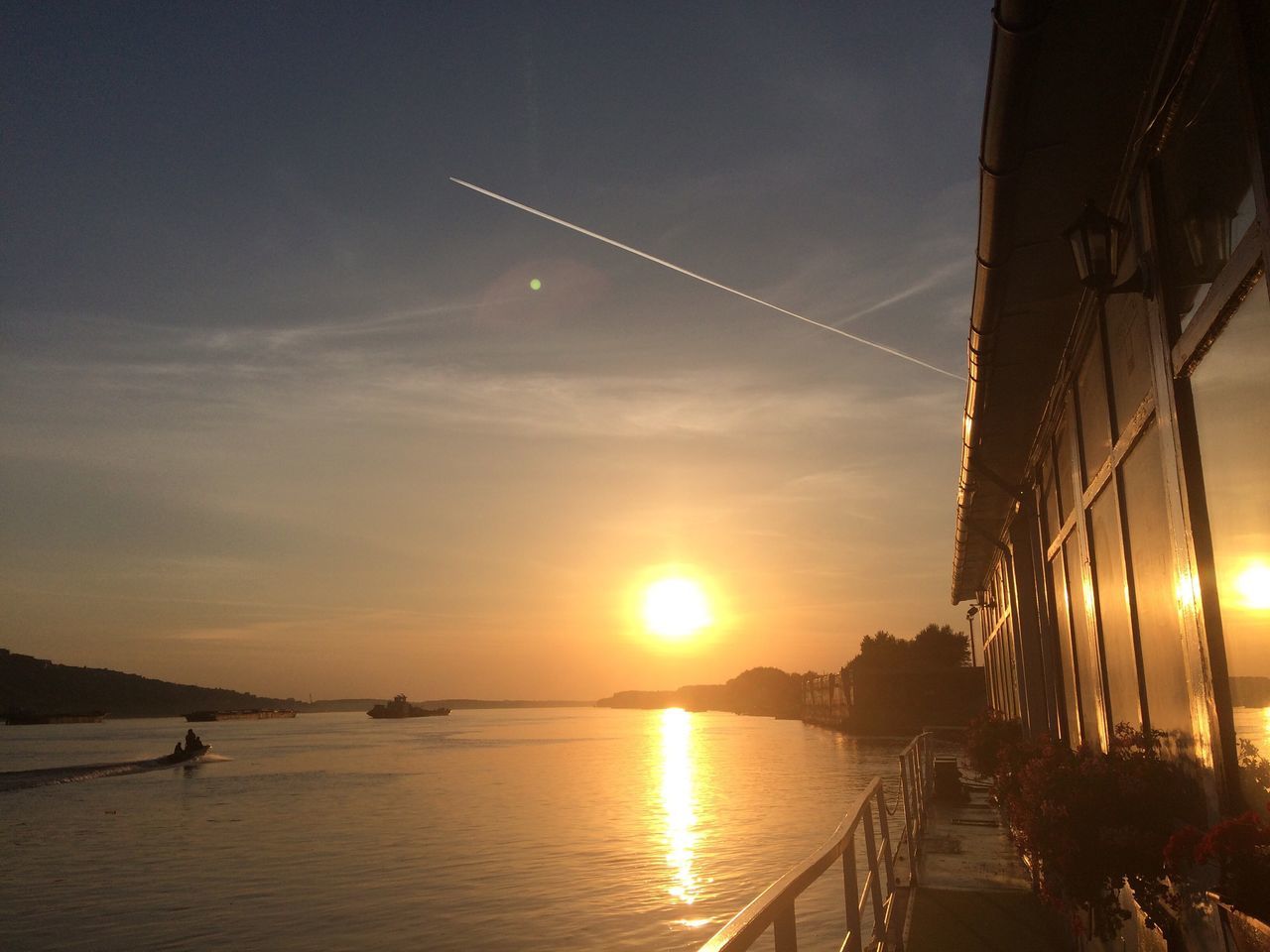 sunset, water, sun, bridge - man made structure, transportation, connection, lake, built structure, architecture, sky, reflection, sunbeam, engineering, scenics, cloud, lens flare, the way forward, beauty in nature, tranquility, moody sky, sea, outdoors, cloud - sky, tranquil scene, nature, dramatic sky, atmospheric mood, bridge