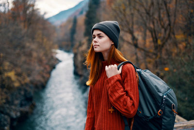 Young woman looking away in forest