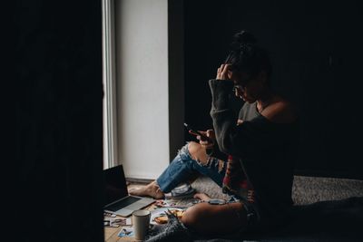 Man using mobile phone at home