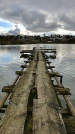 Pier over lake against sky