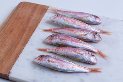 High angle view of fish on cutting board