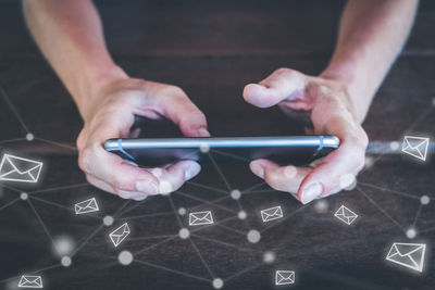 Midsection of man using mobile phone