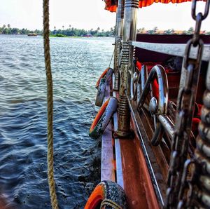 Close-up of chain on boat sailing in river