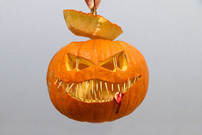 Close-up of pumpkin against orange background