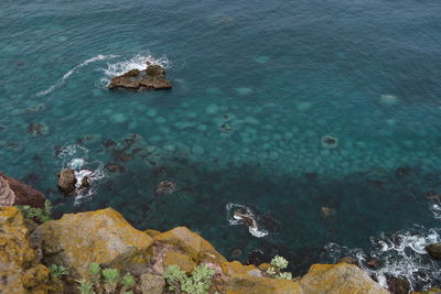 High angle view of rocks in sea