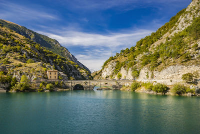 Scenic view of lake and mountains against sky