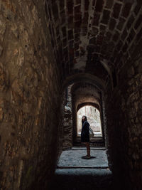 Woman standing in tunnel