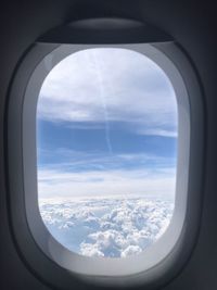 Aerial view of cloudscape seen through airplane window