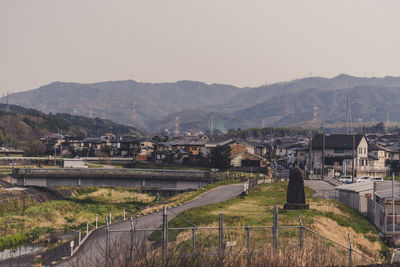 Town by mountains against clear sky