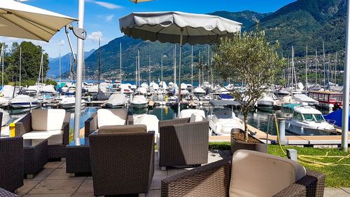 Chairs and tables at restaurant by lake