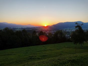 Scenic view of field against sky during sunset