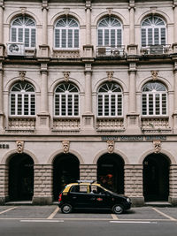 Cars on road by buildings in city