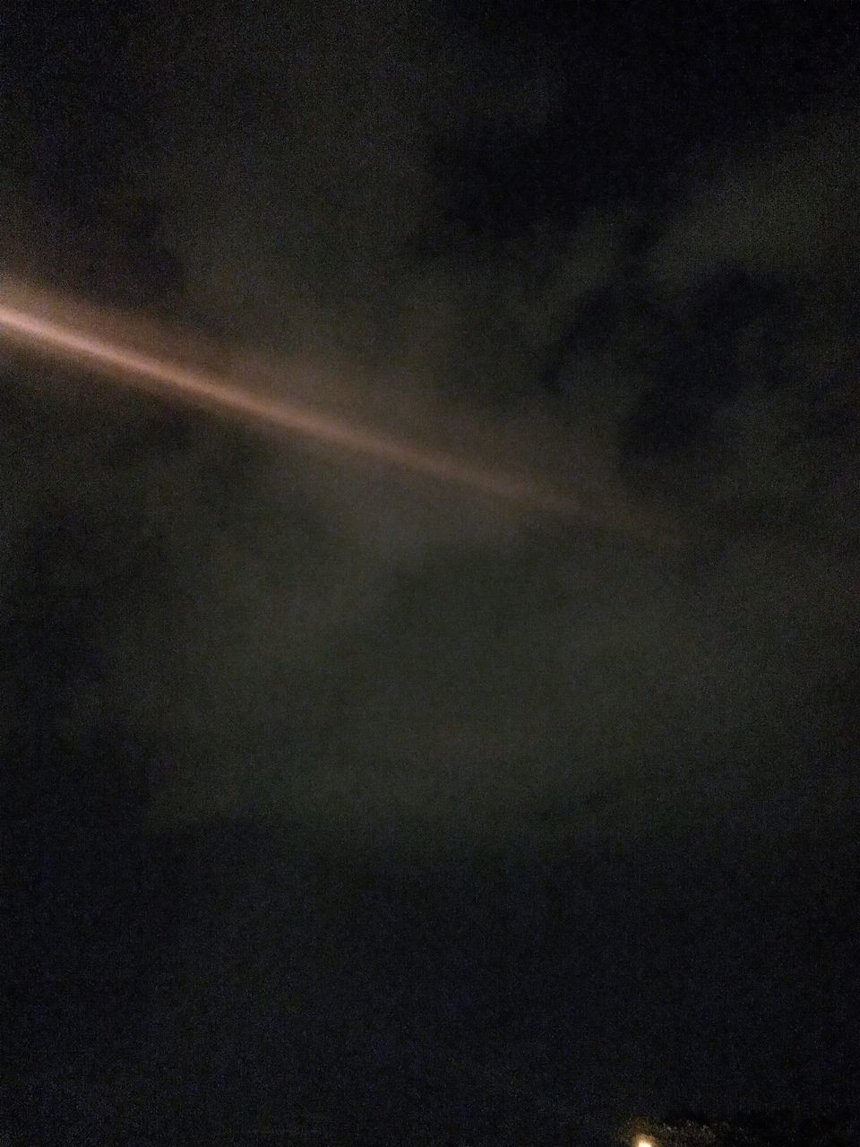 LOW ANGLE VIEW OF VAPOR TRAIL IN SKY AT NIGHT
