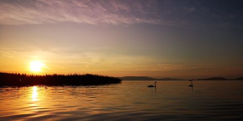 Scenic view of lake against sky during sunset