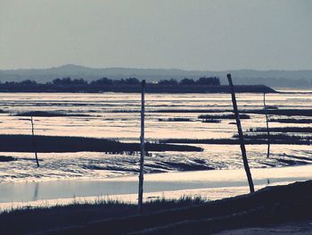 Scenic view of lake against sky during winter