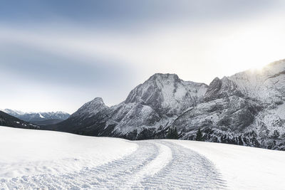 Scenic view of snow covered mountains against sky