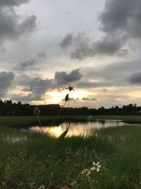 Scenic view of lake against sky during sunset