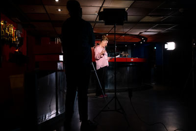 People standing in illuminated room