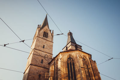 Low angle view of old church against clear sky